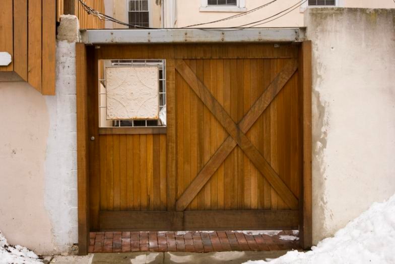 Natural wood sliding barn door with cross bracing