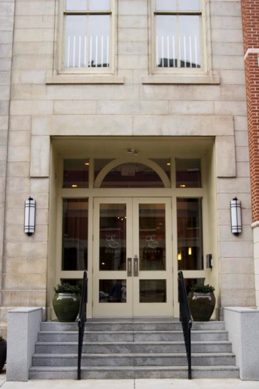 Glazed wood entrance doors and transom on a limestone building