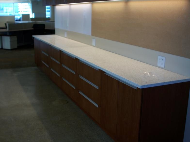Long run of wood base cabinets with solid surface top