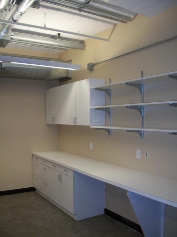 Built-in white shelving and desk casework